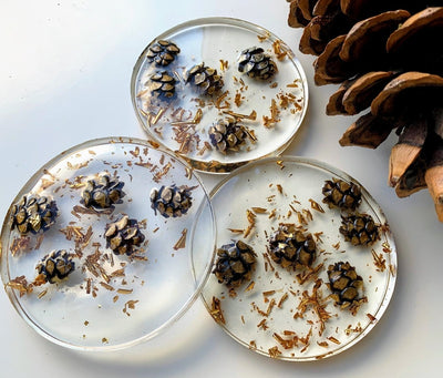 crystal clear epoxy resin coasters with natural and metallic inclusions